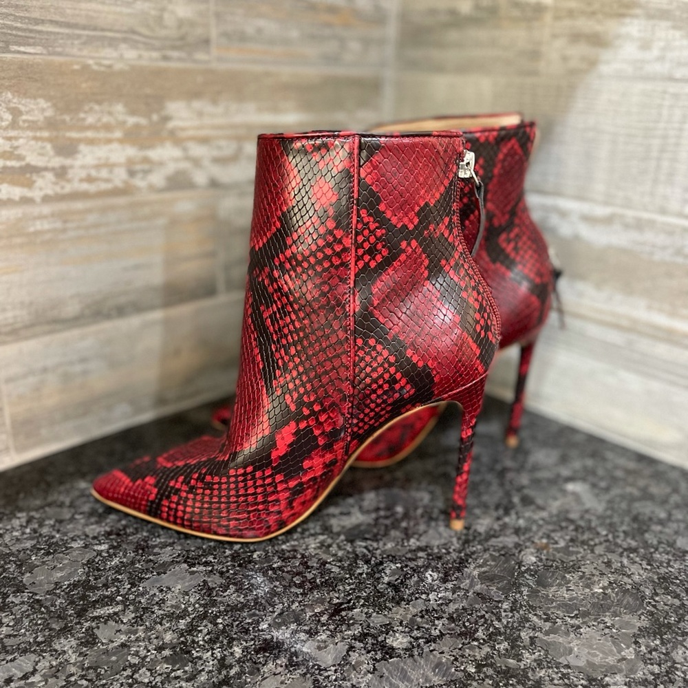 Steve Madden healed read snakeskin boots. Never been worn.